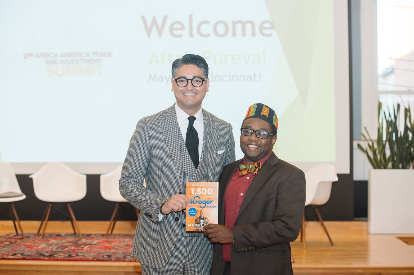 Manny Addo presenting a copy of his book to the Mayor of Cincinnati at the 2024 Africa America Trade & Investment Summit